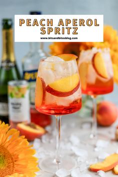 two glasses filled with fruit and ice on top of a table next to sunflowers