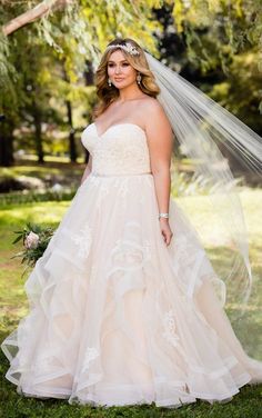 a woman in a wedding dress posing for the camera