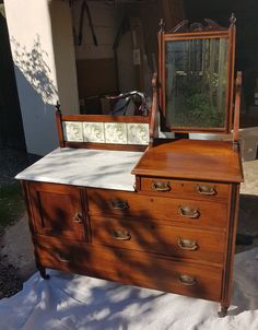 an old dresser with a mirror sitting on top of it