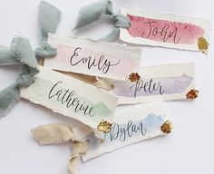 four pieces of torn paper with different colored ribbons on top of each one and the words written in french