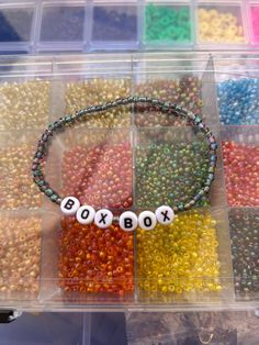 a box filled with beads that spell out the word box