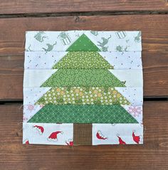 a quilted christmas tree sitting on top of a wooden table