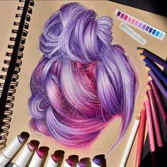 a drawing of a woman's hair with pastel pencils next to it