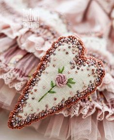 a close up of a piece of cloth with flowers on it and lace around the edges