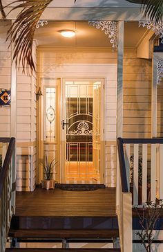 the front porch of a house with stairs leading up to it