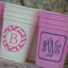 three different colored cups with monogrammed designs on them