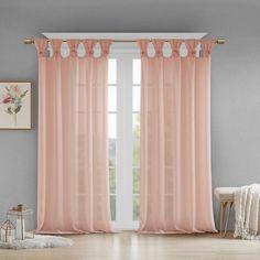 the curtains in this room are pink and have ruffled trims on top of them