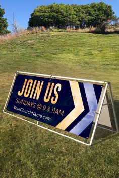 a sign in the grass that says join us