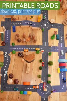 an overhead view of a toy road with cars, trucks and trees on the roadway