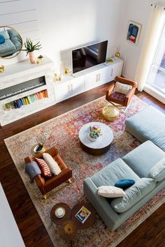 an overhead view of a living room with couches, chairs and a rug on the floor