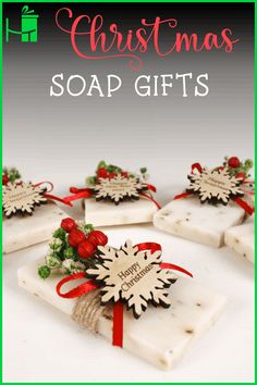 christmas soap gifts with red ribbon and snowflakes on them in front of a white background