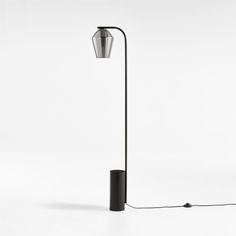 a black floor lamp on a white background with a light bulb attached to the pole