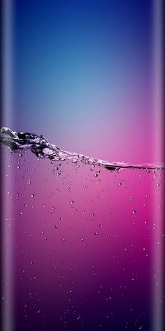 the back side of a cell phone with water droplets on it and a purple background