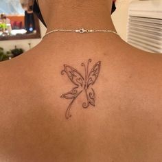 a woman with a butterfly tattoo on her back