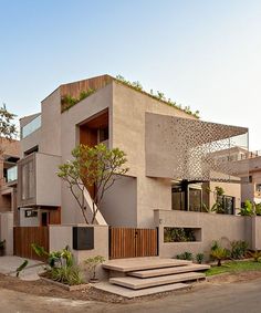 a building with stairs leading up to it and trees growing on the side of it