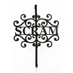 a black metal sign with the word cram on it's side and an ornate design