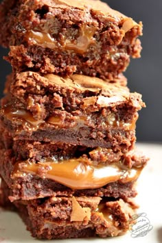 three brownies stacked on top of each other with caramel drizzles