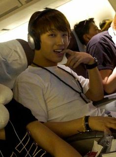 a man sitting in an airplane with headphones on