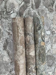 three different types of stone are lined up against a wall with grey and white paint