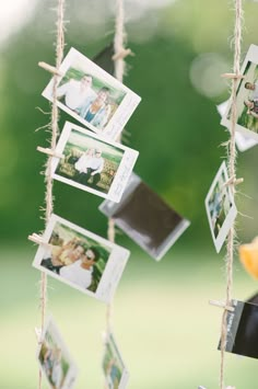 some pictures hanging from a rope with clothes pins attached to them and photos pinned to the strings