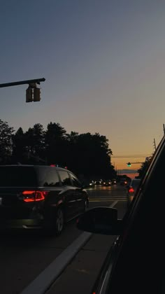 cars stopped at a traffic light in the evening