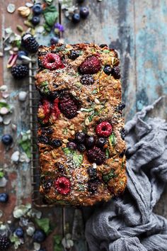 a loaf of bread with berries and nuts on top