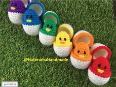 crocheted slippers with angry birds on them are lined up in the grass