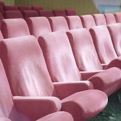 rows of pink seats sitting next to each other