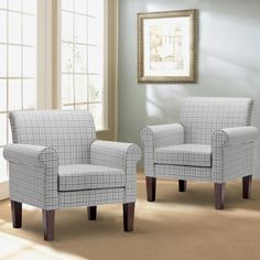 two chairs sitting next to each other in front of a window on top of a carpeted floor