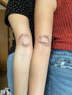 two women with matching tattoos on their arms