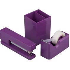 purple office supplies including a roll of toilet paper and a tape dispenser