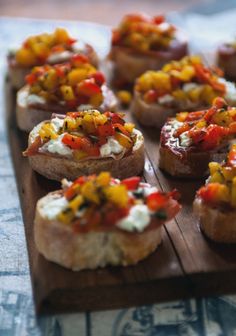 small appetizers are arranged on a wooden tray