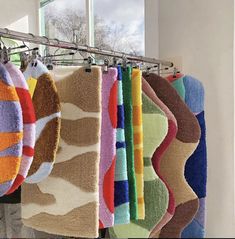 towels hanging on a rack in front of a window