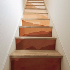 the stairs are painted with different shades of orange and brown on each side, along with white walls