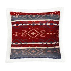 a red, blue and white pillow with fringes on the front is featured in this image