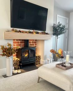 a living room with a fireplace and television above it