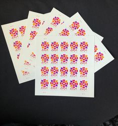 four stickers with different designs on them sitting next to each other in front of a black background