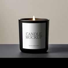 a candle that is on top of a black table with the words candle mockup printed on it