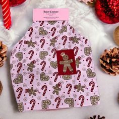 a dog bandana with gingerbreads, candy canes and a teddy bear on it