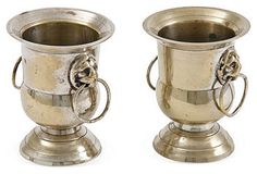 two silver cups sitting on top of each other