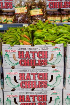 boxes of green peppers are stacked on top of each other