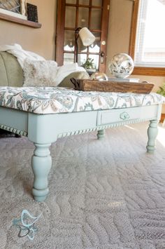 a living room with a couch, coffee table and other items on the carpeted floor