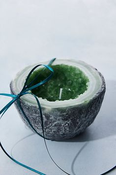 a candle that is sitting in a bowl