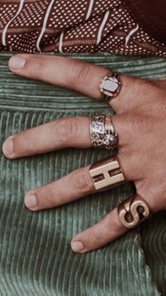 a woman's hand with two rings on her finger and one ring in the middle