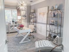 a living room filled with furniture and a chandelier