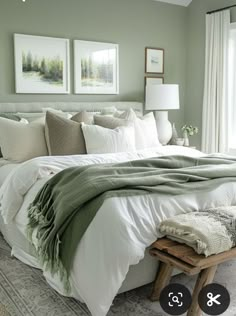 a bedroom with green walls and white bedding