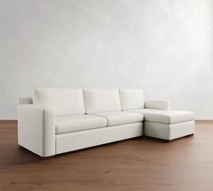 a white couch sitting on top of a wooden floor