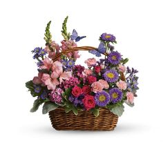 a basket filled with lots of colorful flowers