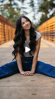 a woman sitting on the ground with her legs crossed