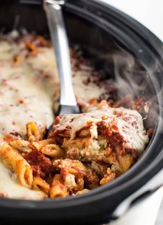 a slow cooker filled with pasta and sauce